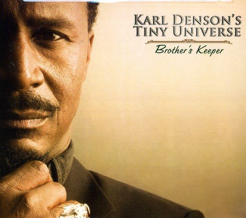 Album cover with a man in a suit, hand on chin, against a beige background.