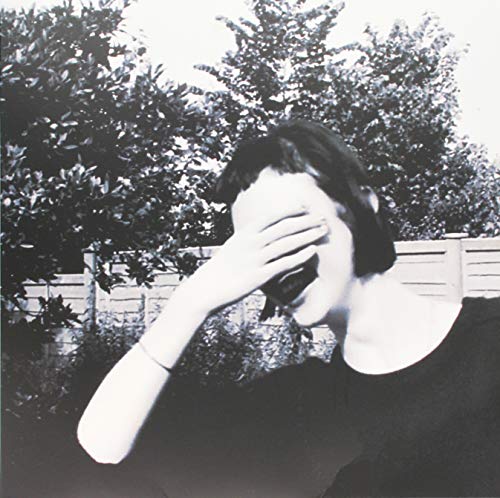 A black-and-white vinyl record cover featuring a person covering their face.