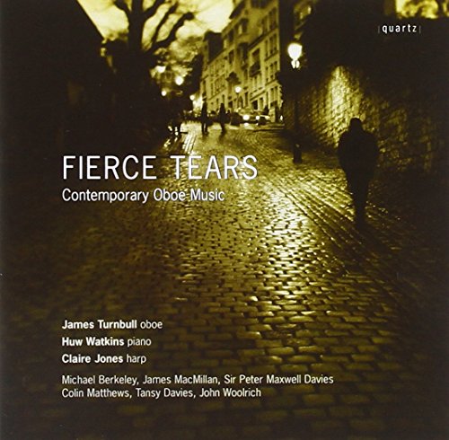 A CD cover with a dimly lit cobblestone street and white text overlay.