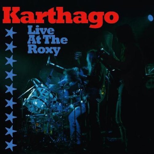 "Album cover with a band performing on stage, surrounded by blue stars."
