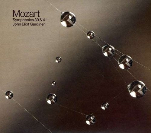 CD cover featuring Newton's cradle with shiny metal balls on a brown gradient background.