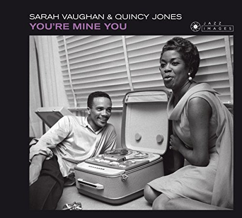 Black and white album cover featuring a man and woman with an open suitcase.