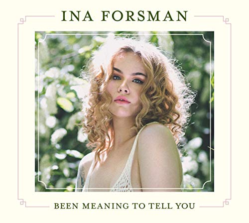 Album cover with blonde woman in white top against a floral background.