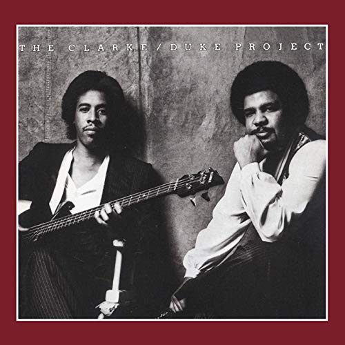 Album cover with Stanley Clarke and George Duke holding a bass, against a maroon background.