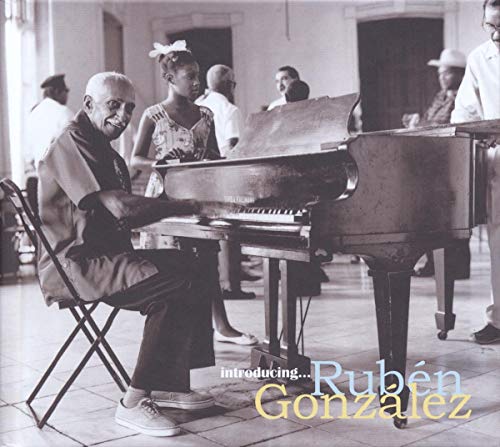 "Black and white album cover featuring a man playing a grand piano."