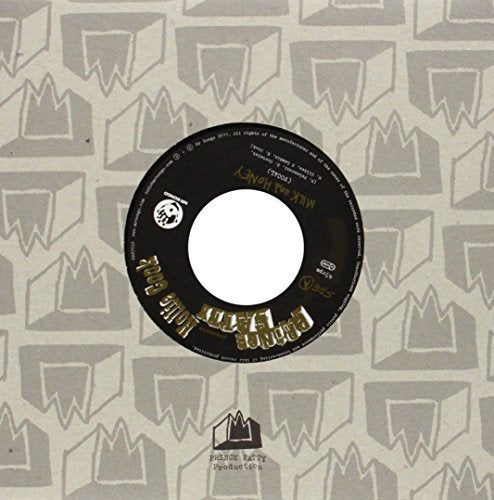Black vinyl record with gold text on a patterned grey and beige background.