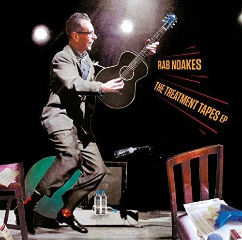 Album cover of "The Treatment Tapes EP" by Rab Noakes, man playing guitar on stage.