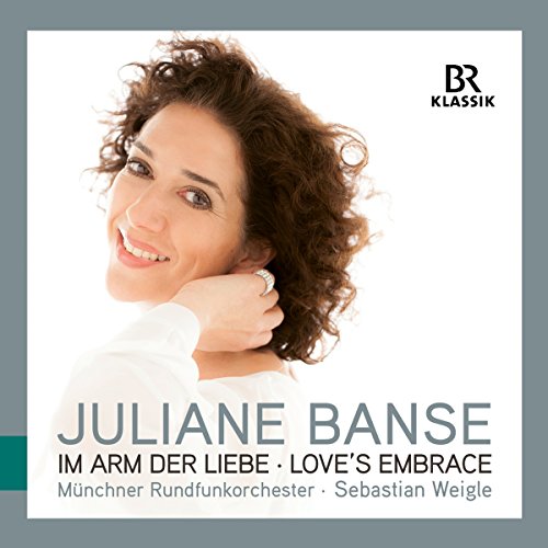 "CD cover featuring a smiling woman with curly brown hair."
