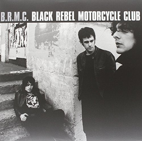"Black and white album cover featuring three men in dark clothing."