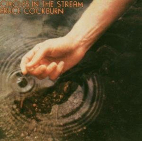 "Album cover with hand creating ripples in water, titled 'Circles in the Stream' by Bruce Cockburn."