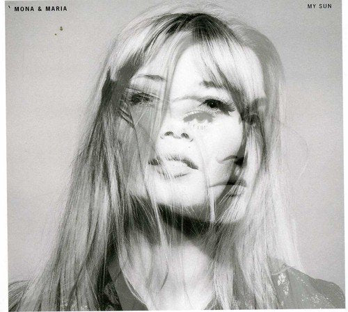 Black and white album cover featuring a woman with long hair covering her face.