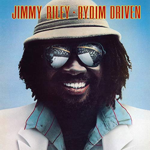 Album cover featuring a man with dreadlocks, wearing sunglasses, hat, and white jacket.