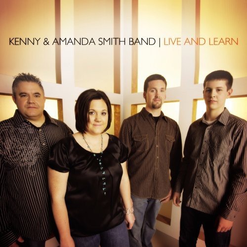 "Album cover featuring four band members standing together, wearing dark, patterned clothing."