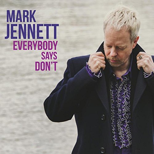 Album cover featuring a man with blonde hair, wearing a dark jacket and patterned shirt.