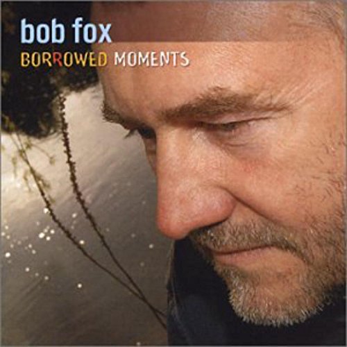 Album cover with a close-up of a man's face and the title "Borrowed Moments".