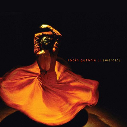 "Album cover featuring a dancer in orange dress, arms raised, against a dark background."