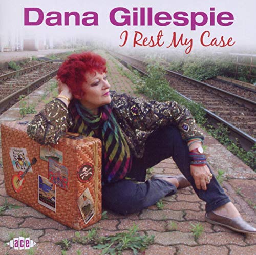"CD cover featuring a woman sitting on train tracks with a suitcase."