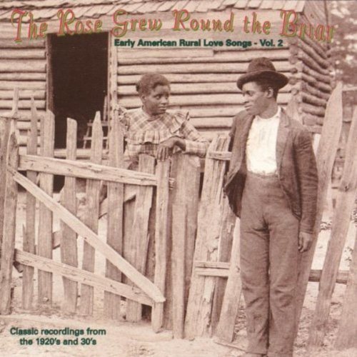 "Sepia-toned album cover with a man and child by a wooden fence."