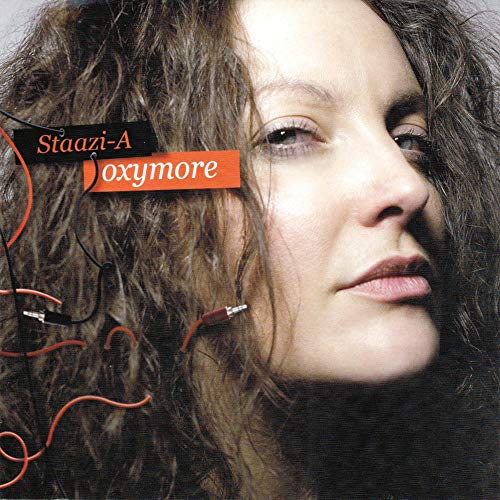 CD album cover featuring a woman with curly hair and wired earbuds.