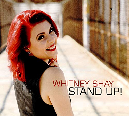Red-haired woman smiling, album cover for Whitney Shay’s “Stand Up!”.