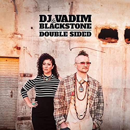 Album cover with man and woman standing in front of a concrete wall.