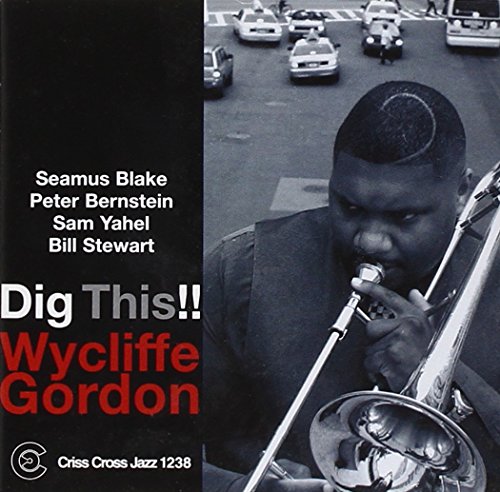 "Album cover with a man playing a trombone on a city street."