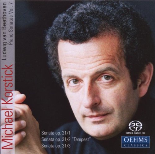 CD cover featuring a man with short dark hair against a dark background.