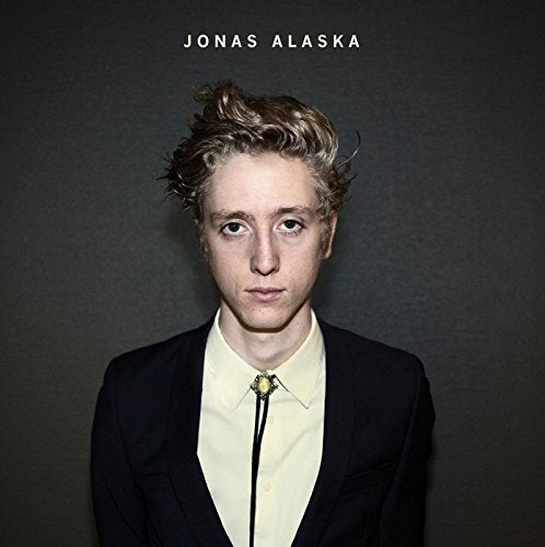 "Album cover featuring Jonas Alaska, a man with messy hair, wearing a black jacket."