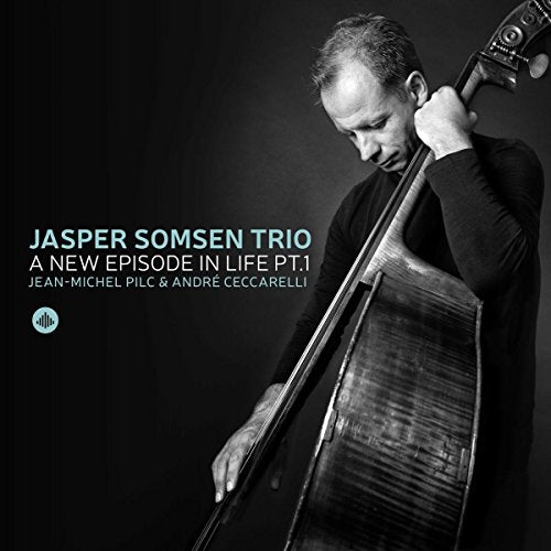 "CD cover with a man holding a double bass, black and white image."