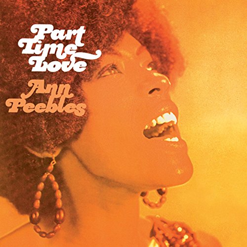 "Album cover featuring a close-up of a woman with an afro, wearing large earrings."