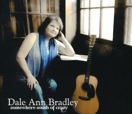 "Dale Ann Bradley sits beside a guitar, wearing blue, on a CD cover."