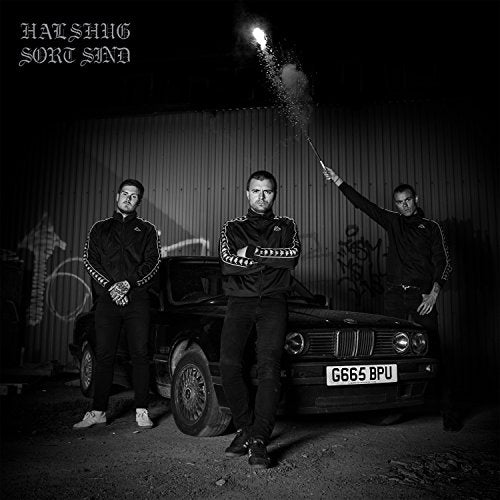 "Black and white image of three men standing beside a BMW car at night."