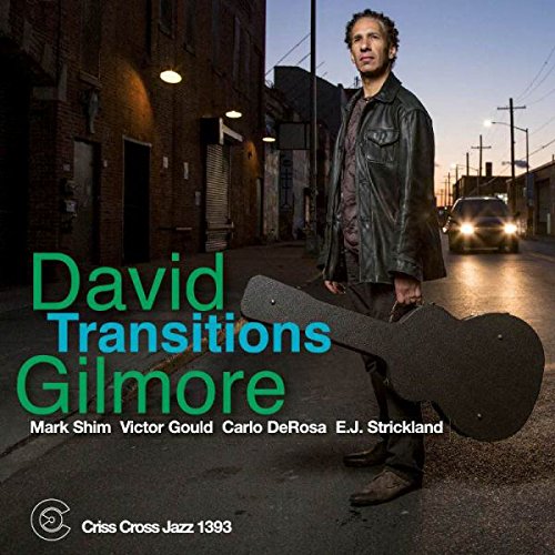 "Album cover featuring a man holding a guitar case on a city street."