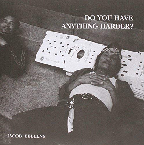 Black and white album cover with two men lying on concrete steps.