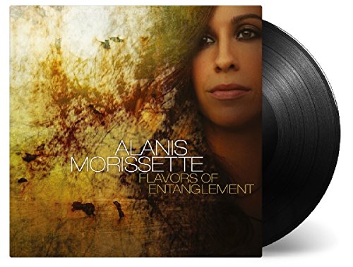 Vinyl record cover with Alanis Morissette's face, abstract background, and partially visible black vinyl.