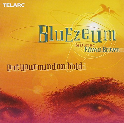 "Album cover featuring a face with eyes, yellow and red gradient background, 'Bluezeum' text."