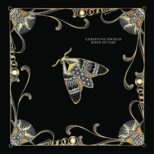 "Album cover with black background, gold border, and moth illustration, titled 'When On Fire'."