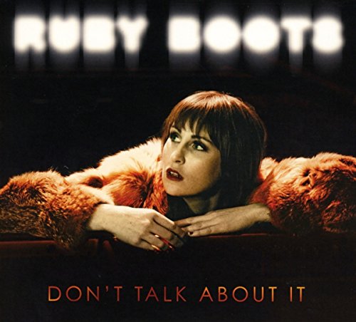 "Album cover featuring a woman in a fur coat, leaning on a surface."