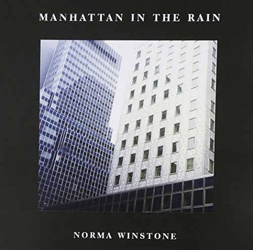 "Album cover with cityscape photo of two skyscrapers on a black background."