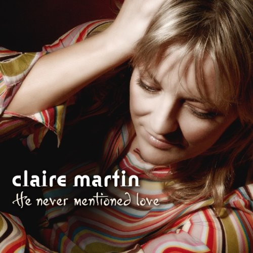 "Album cover featuring a woman with blonde hair, wearing a striped shirt, with text overlay."