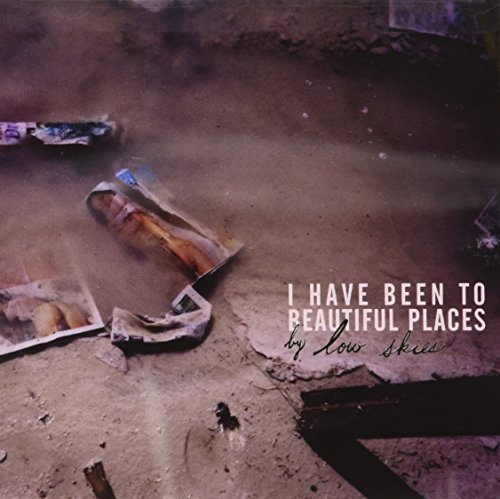 "Album cover with crumpled paper on the ground and white and black text overlay."