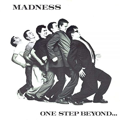 Black and white album cover featuring six men in suits dancing in a line.