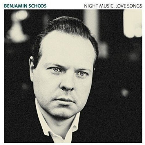 "Album cover with black-and-white portrait of a man, white border, and artist's name."