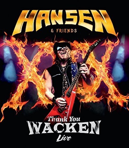 Kai Hansen holding a guitar, surrounded by flames, on a concert album cover.