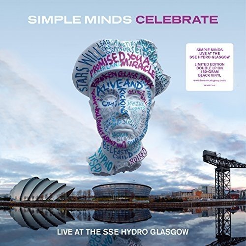 "Album cover featuring a word-filled head sculpture above a building and cloudy sky."