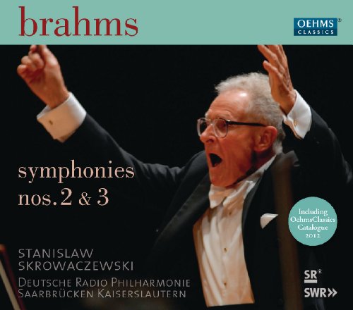 "CD cover with conductor in tuxedo, arms raised, against a black background."