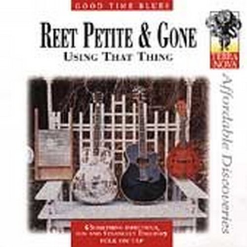 "Album cover with three guitars on a bench, white picket fence in background."