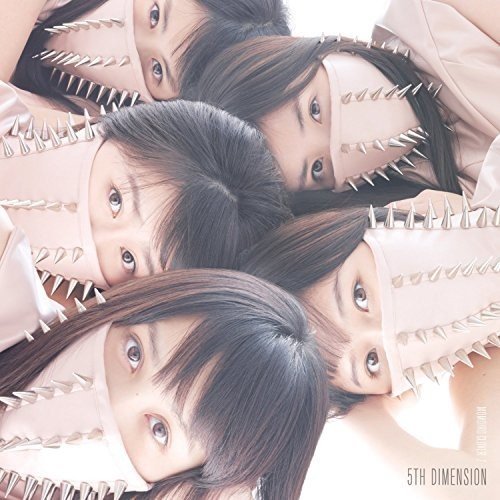 Four women in pink outfits with spiked shoulders, looking directly at the camera.