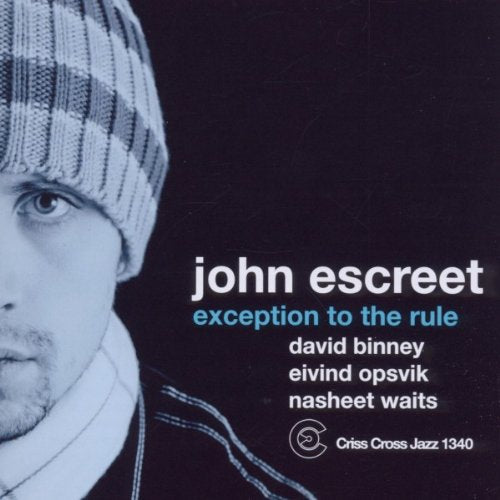 Album cover with a man wearing a beanie, against a black background.