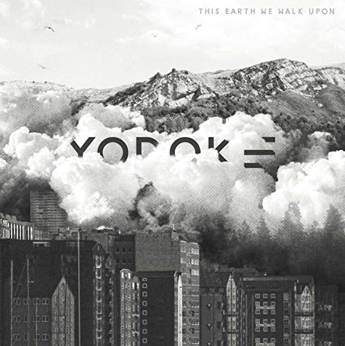 "Black and white cityscape with mountains and clouds, 'YODOK III' text overlay."